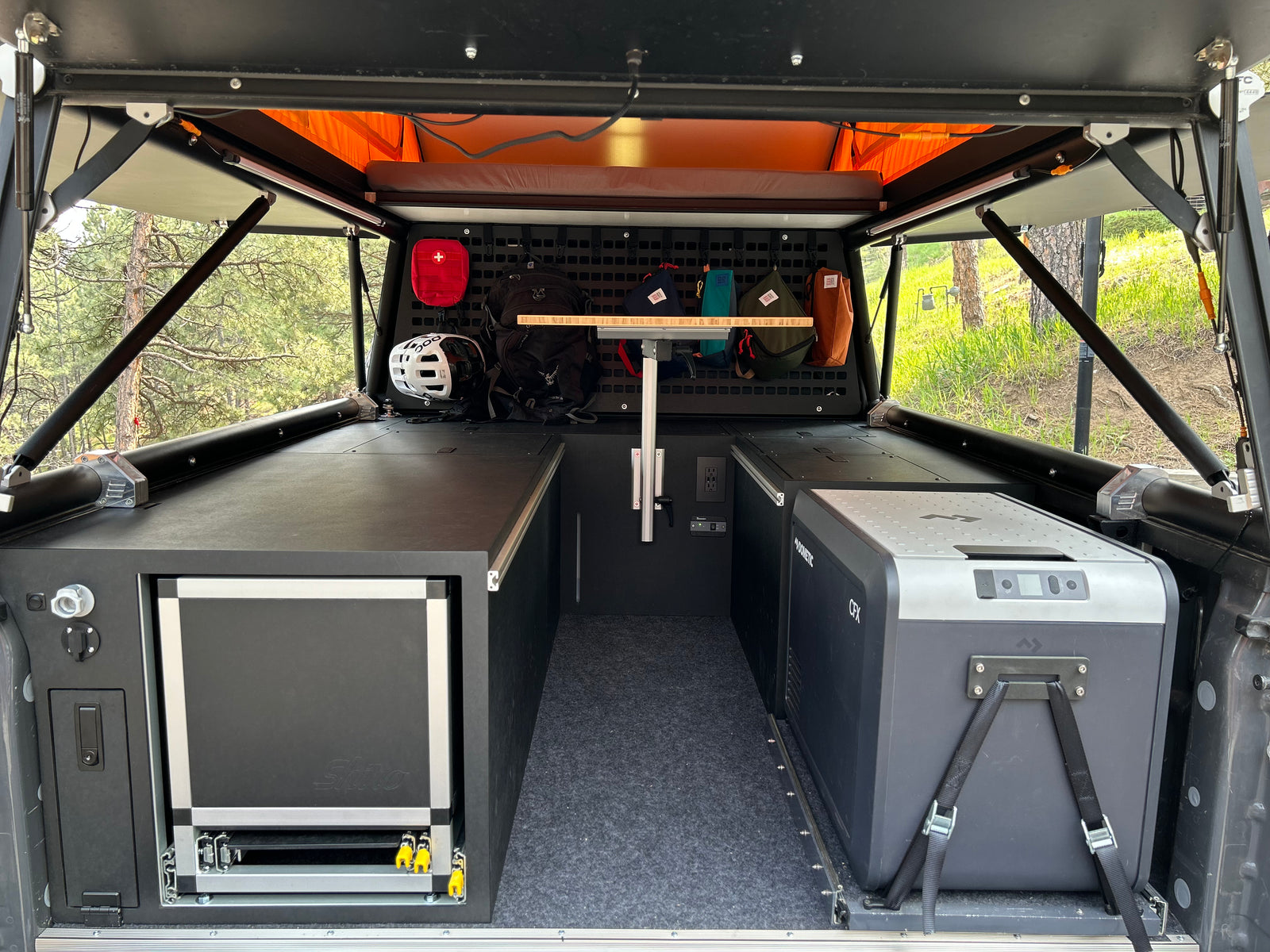 Go Fast Camper (GFC) build - Interior storage cabinets view with camp kitchen and slide out refrigerator