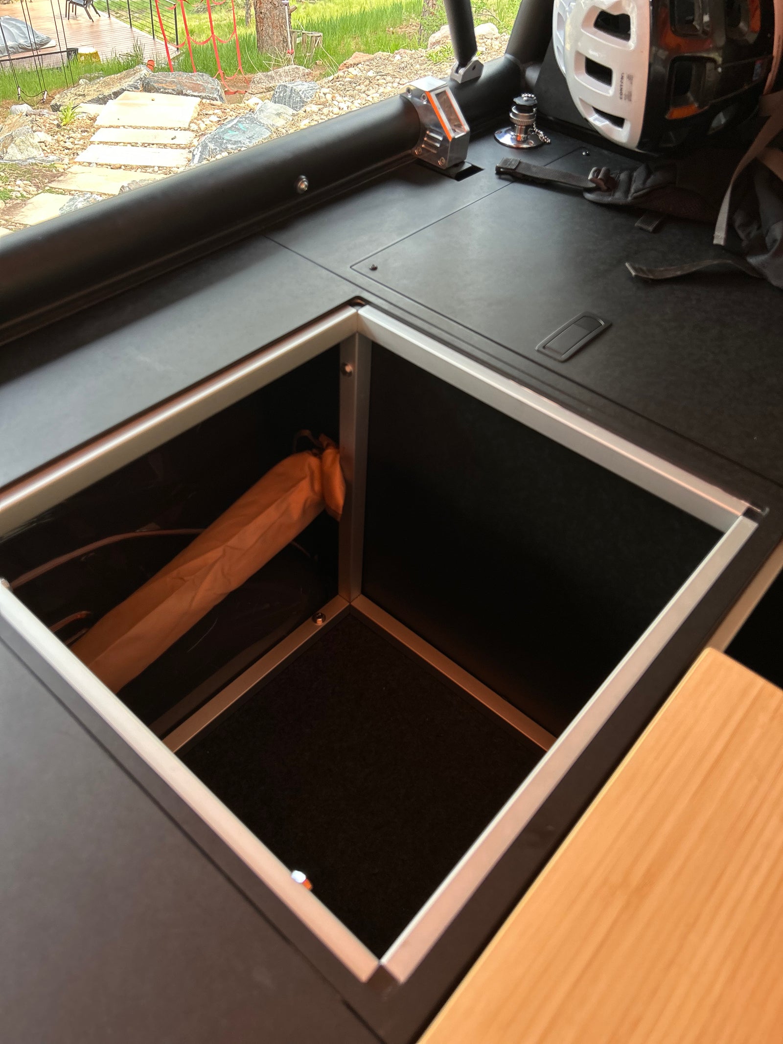 Go Fast Camper (GFC) build - Interior storage cabinet open, showing wheel arch overhang